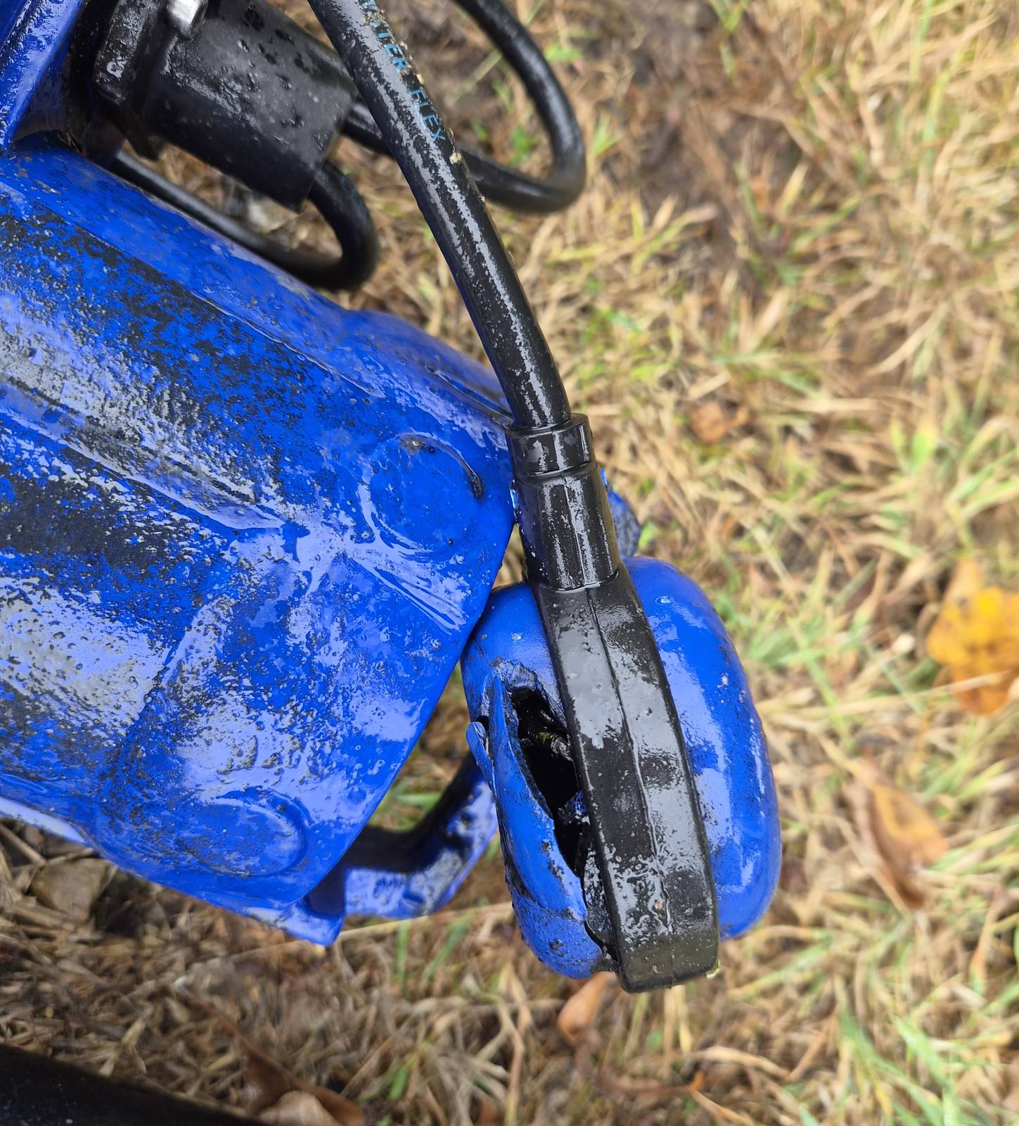 Blue submersible pump and float switch lifted out for servicing