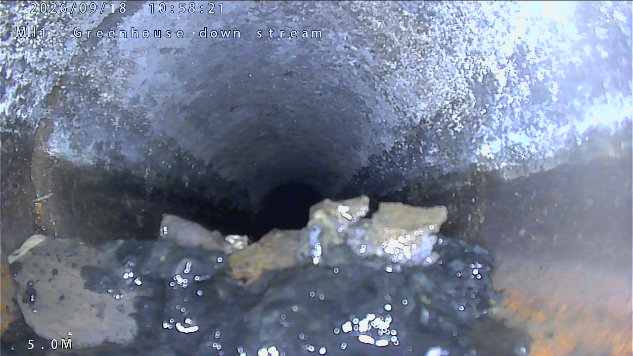 CCTV still inside a drain pipe blocked by fat and grease buildup
